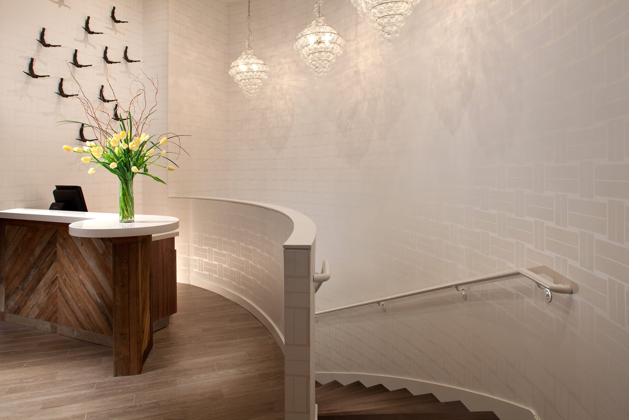 The Spa entrance at Kona Kai with a large open space, beautiful tulips and 3 gorgeous chandeliers